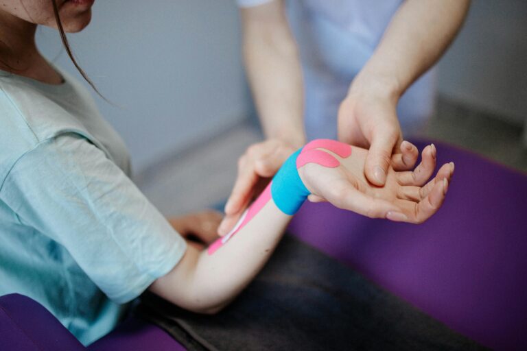 Person getting their wrist taped for joint pain