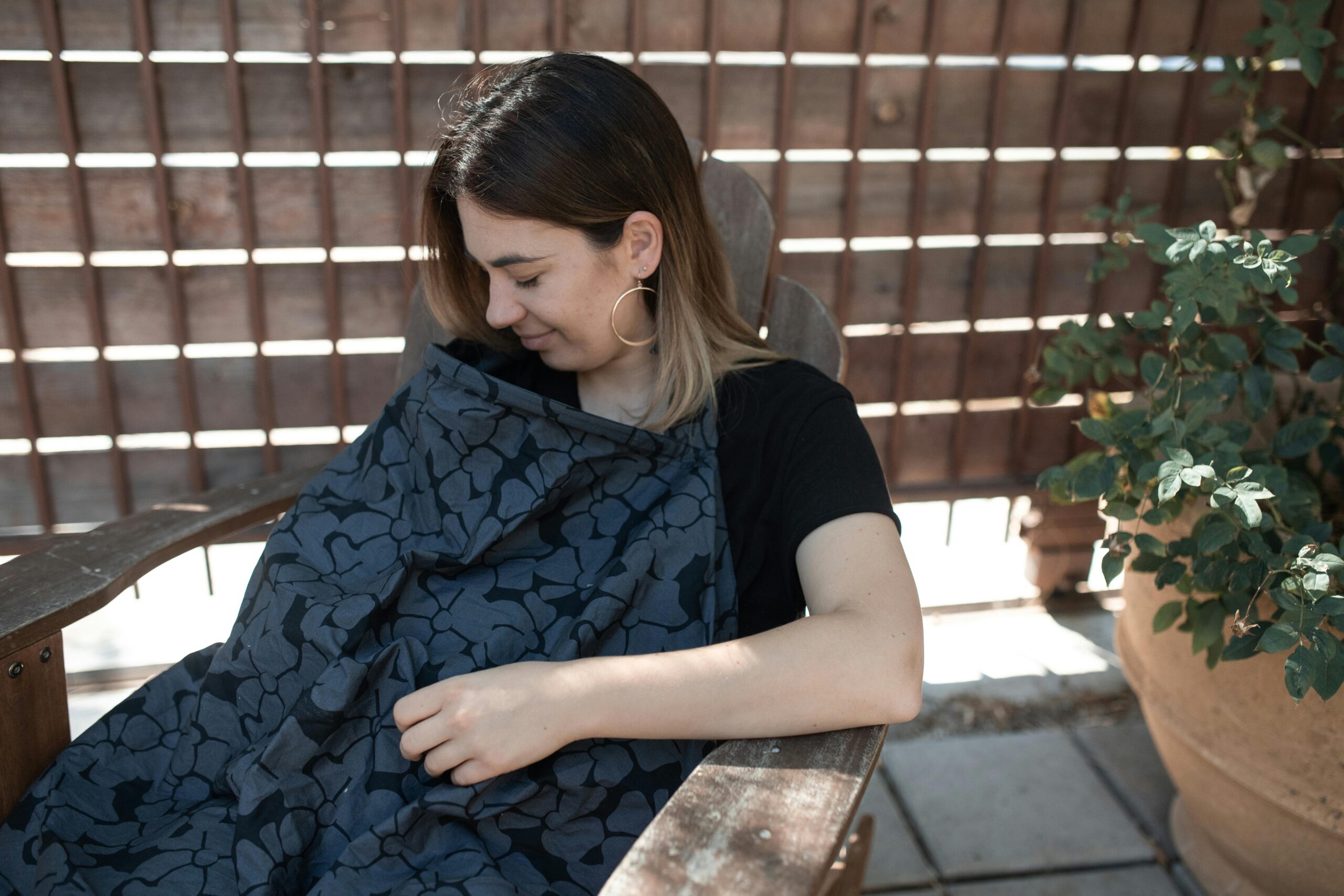 Woman breastfeeding with cover