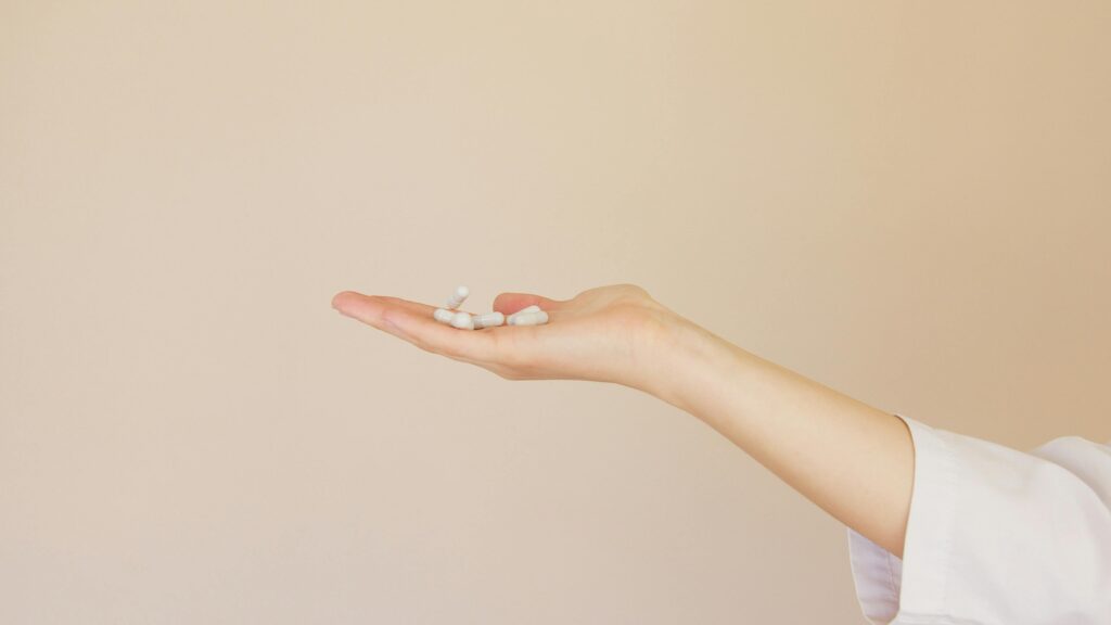 A hand holding iron supplements