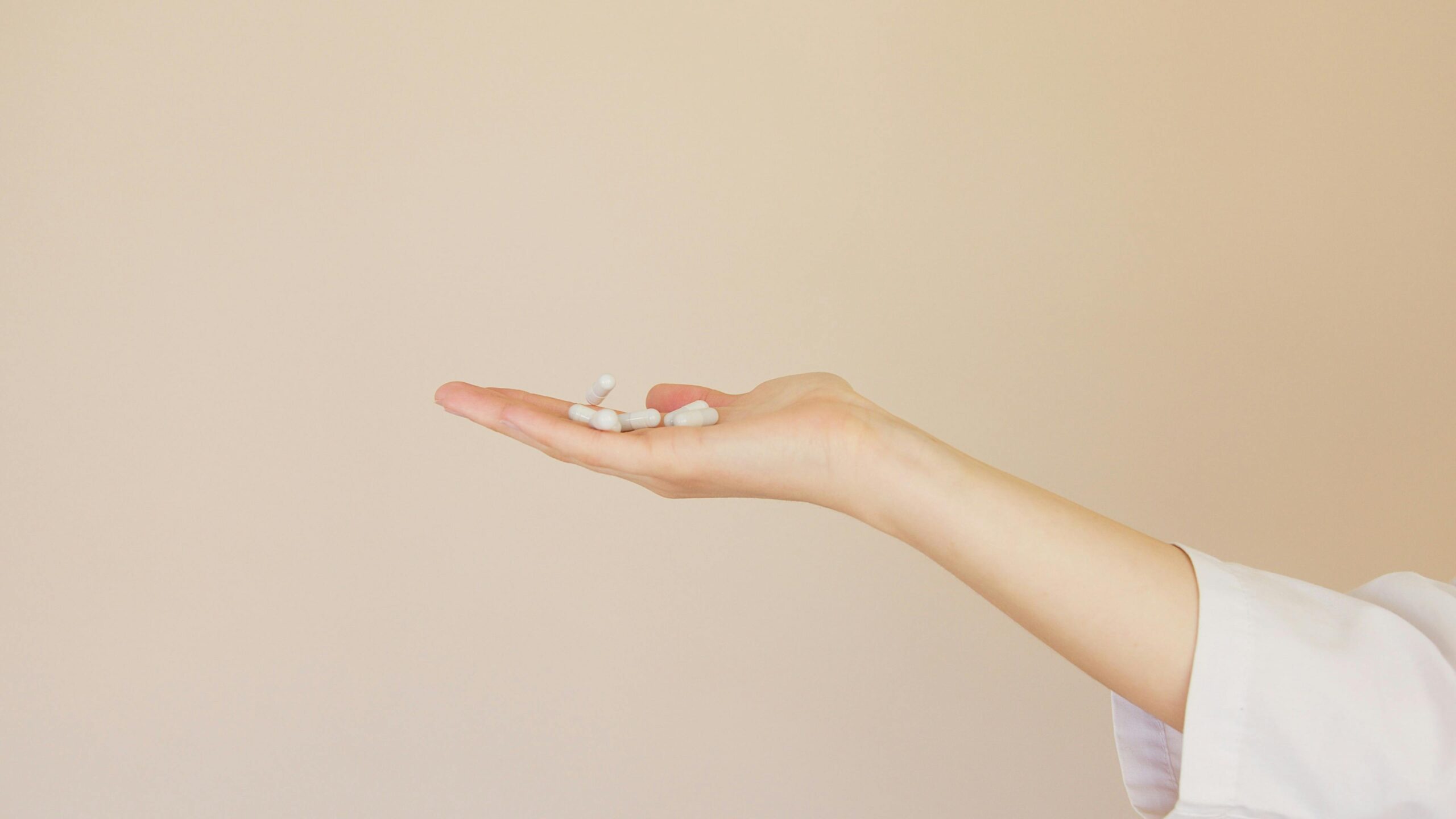 A hand holding iron supplements